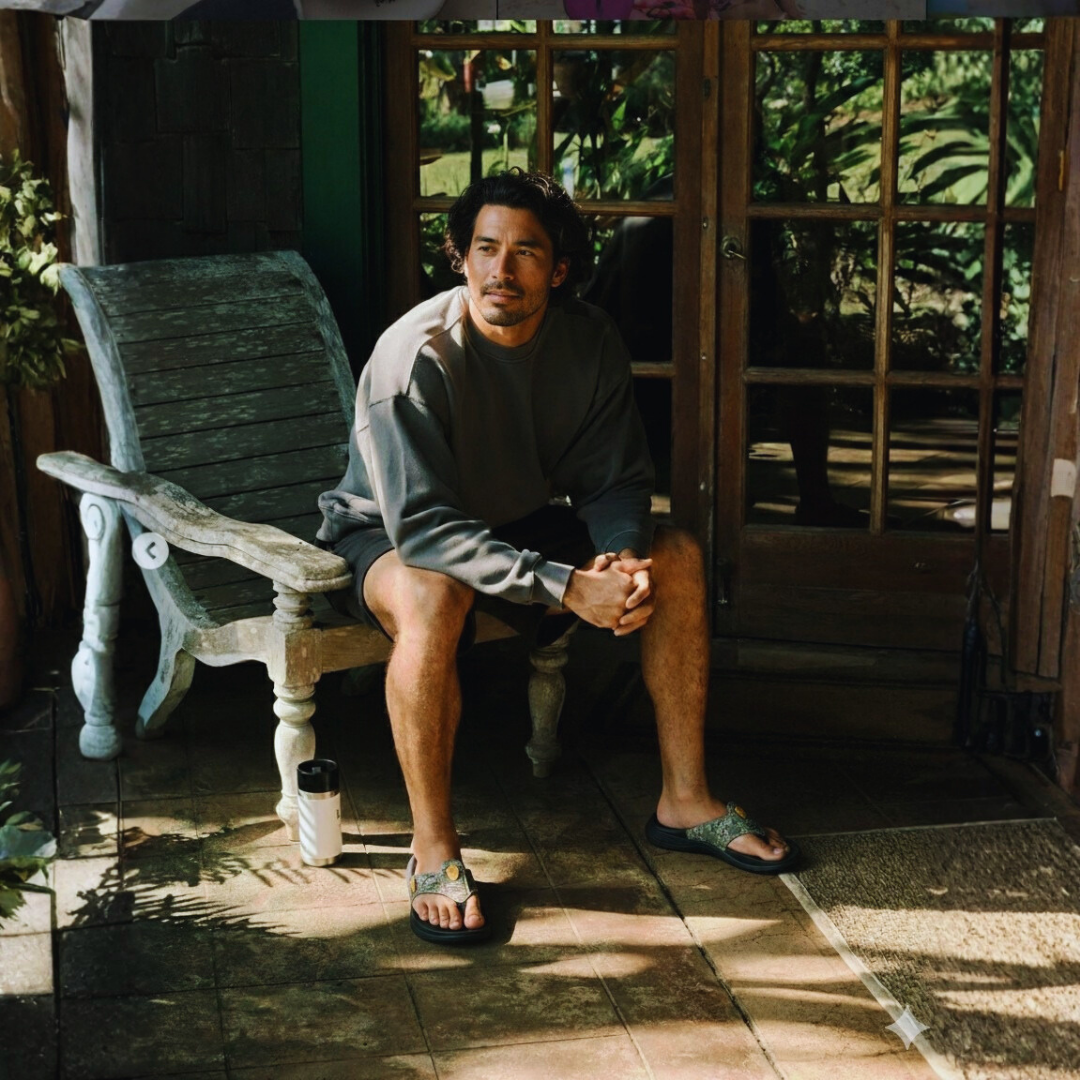 The man is wearing army green camo arch support flip-flops